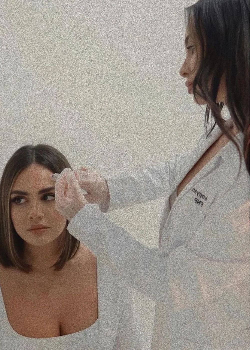 Woman receiving beauty treatment in sterile environment.